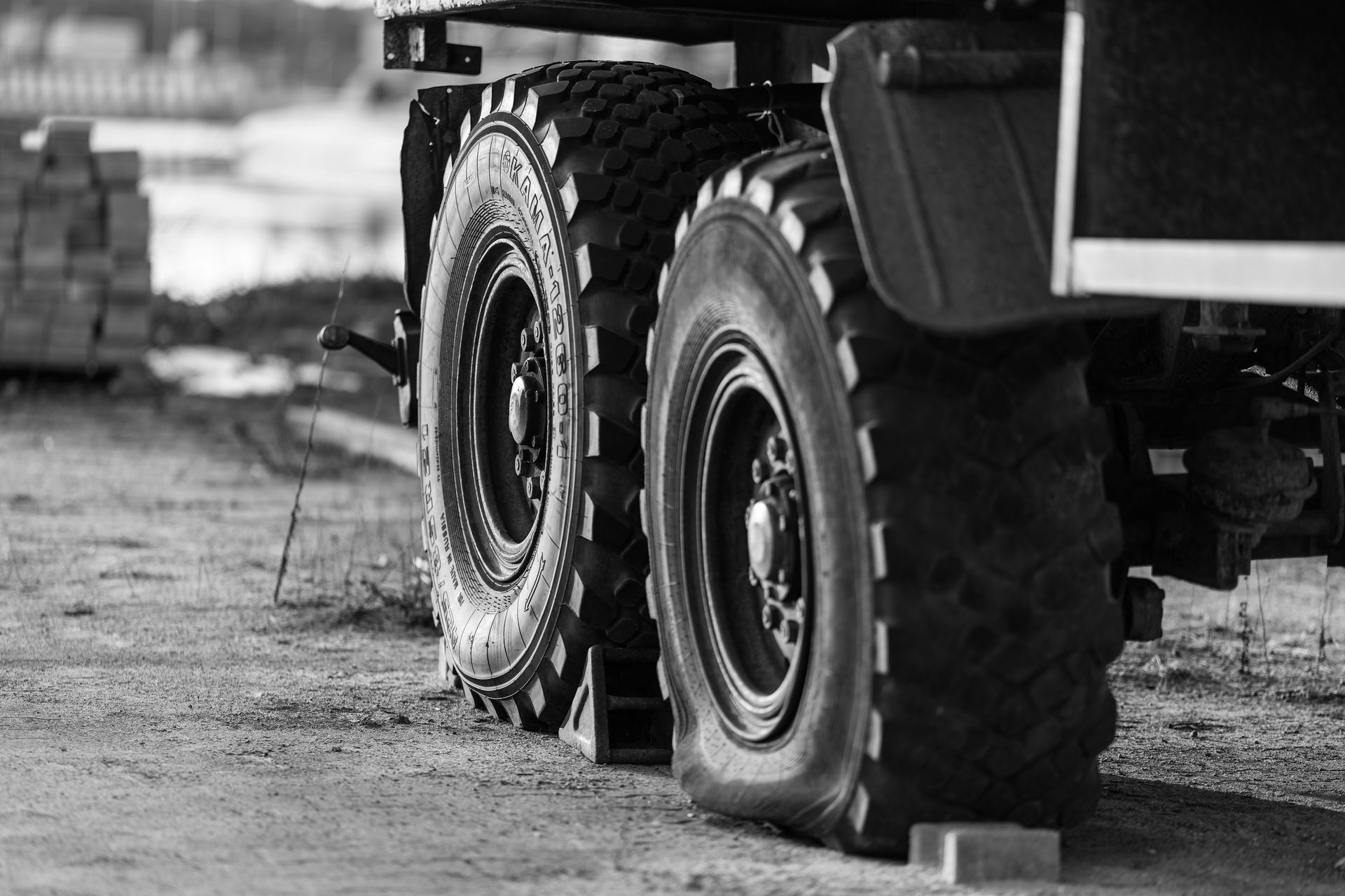 Black and white close-up of truck tires at a construction site in Kaliningrad, Russia.