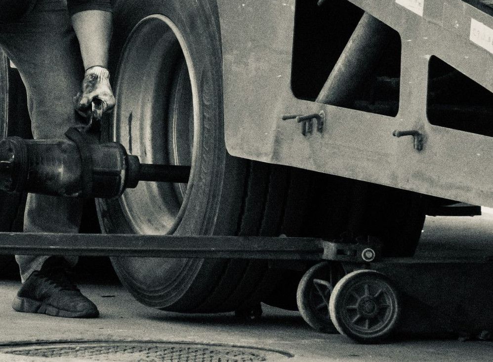 man in black t-shirt and pants holding black metal pipe